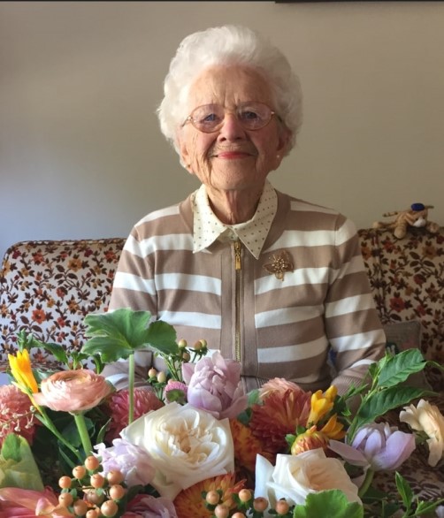Portrait in front of a bouquet of flowers